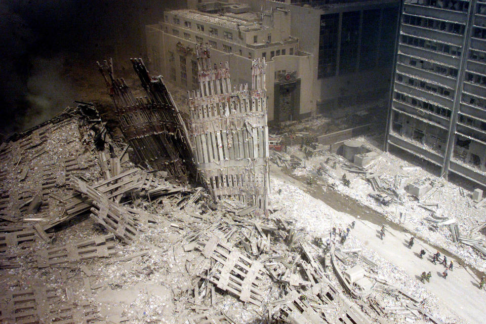 Lilliputian figures -- firefighters stark against the grayish white dust that blanketed so much of lower Manhattan -- walk a path cleared of rubble near the base of the destroyed south tower in the days after the attacks. Aside from the still-staggering scale of the destruction, however, what truly astonishes in Peter Morgan's picture is the suggestion -- as one senses amid Roman ruins, for example, or in ash-entombed figures from Pompey -- of an entire civilization's wreckage. There is an ancient feel to the photograph that sparks a lingering question: Is this the literal end of the figurative "American Century"? <br><br>(Photo: PETER MORGAN/Reuters /Landov )<br><br>For the full photo collection, go to <a href="http://www.life.com/gallery/59971/911-the-25-most-powerful-photos#index/0" rel="nofollow noopener" target="_blank" data-ylk="slk:LIFE.com;elm:context_link;itc:0;sec:content-canvas" class="link ">LIFE.com</a>