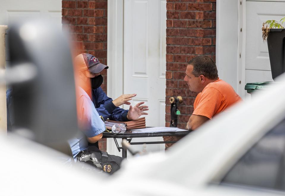 Brooks Houck, right, is seen talking with federal agents at his Glenview Drive residence in Bardstown, Ky. Thursday, Aug. 6, 2020.