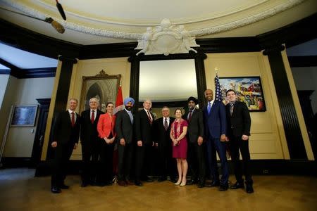 U.S. Homeland Security Secretary John Kelly (5th L) poses for a group photo with Parliamentary Secretary to the Minister of Foreign Affairs Andrew Leslie (L), Transport Minister Marc Garneau (2nd L), Science Minister Kirsty Duncan (3rd L), Innovation, Science and Economic Development Minister Navdeep Bains (4th L), Public Safety Minister Ralph Goodale (5th R), Foreign Minister Chrystia Freeland (4th R), Defence Minister Harjit Sajjan (3rd R), Immigration Minister Ahmed Hussen (2nd R) and Parliamentary Secretary to the Minister of Fisheries Terry Beech. REUTERS/Chris Wattie