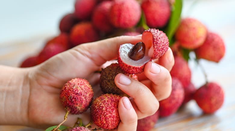 hand holding lychee fruit