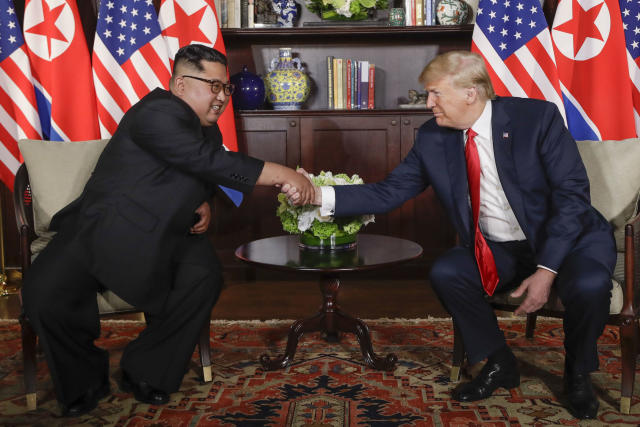 Historic moment: Kim Jong-un and Donald Trump shake hands in Singapore during their landmark meeting. (AP)