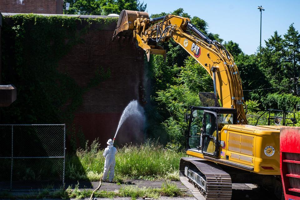 Construction workers use an excavator on the corner of the YMCA building during a press conference for the start of demolition of the YMCA building in the city of Poughkeepsie, NY on Monday, June 6, 2022.
