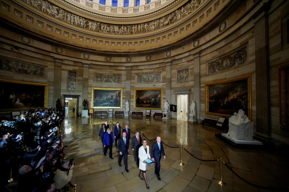 FILE PHOTO: House Sergeant at Arms Irving and House Clerk Johnson carry impeachment articles during procession at the U.S. Capitol in Washingto