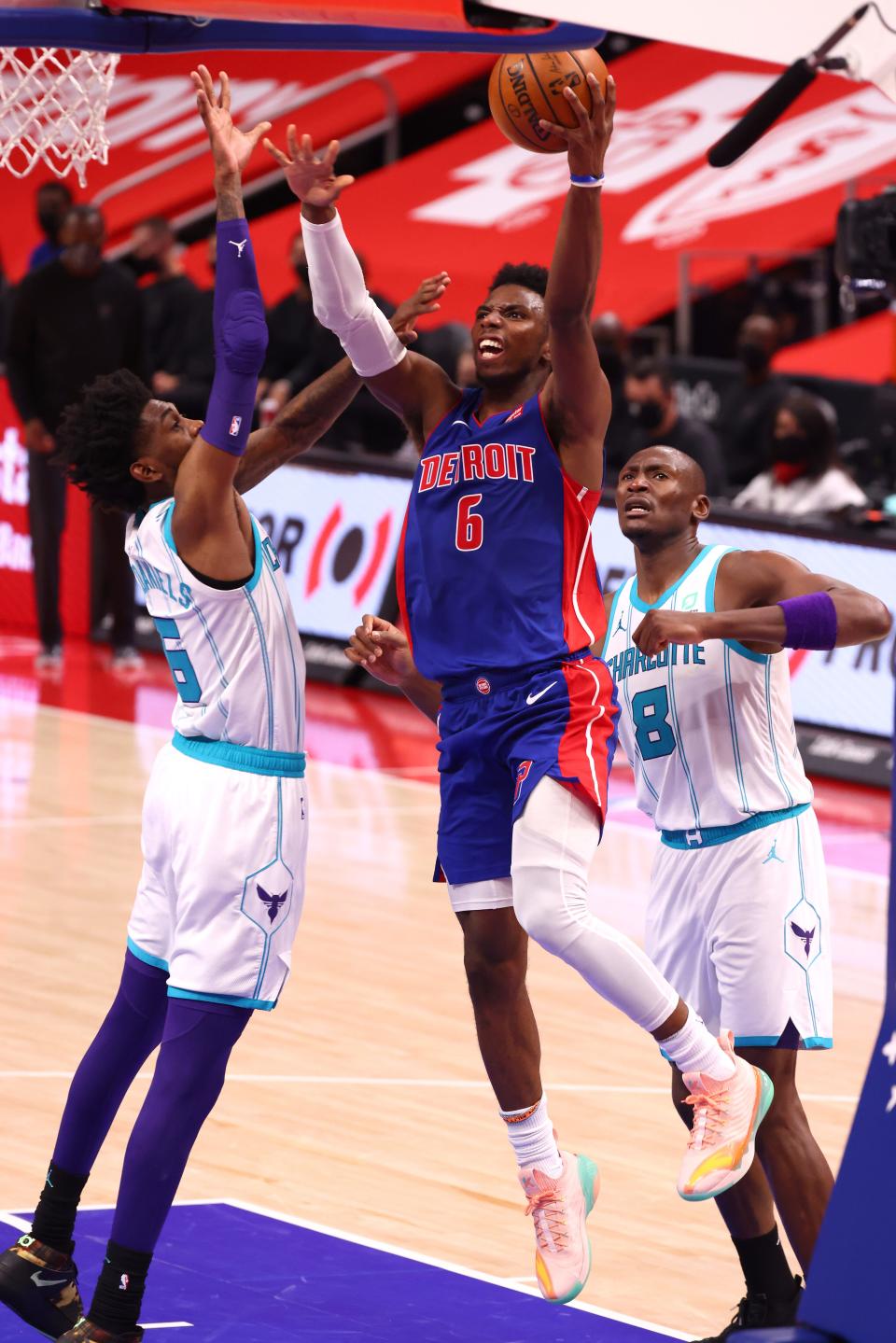 Hamidou Diallo of the Detroit Pistons drives to the basket past Jalen McDaniels of the Charlotte Hornets during the second half at Little Caesars Arena in Detroit on Tuesday, May 4, 2021.