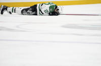 Dallas Stars left wing Mason Marchment holds his face on the ice after a collision during the first period of Game 4 of the team's NHL hockey Stanley Cup second-round playoff series against the Seattle Kraken on Tuesday, May 9, 2023, in Seattle. (AP Photo/Lindsey Wasson)