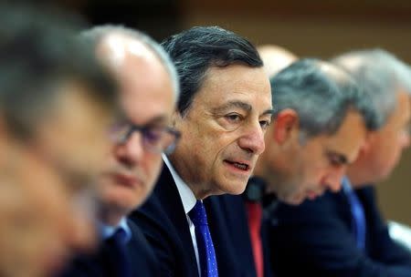 European Central Bank (ECB) President Mario Draghi (C) addresses the European Parliament's Economic and Monetary Affairs Committee in Brussels, Belgium November 28, 2016. REUTERS/Yves Herman