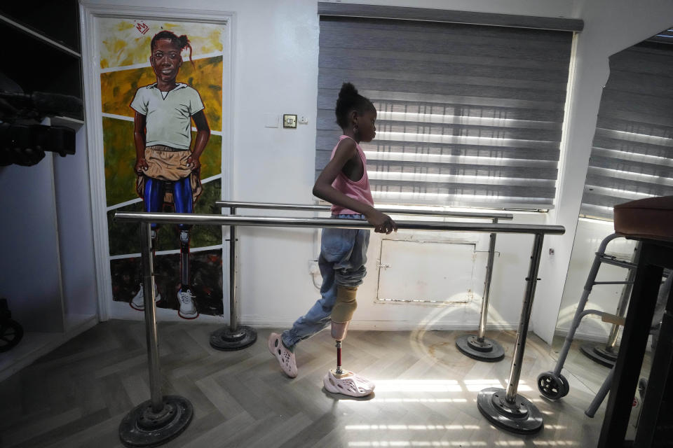 Princess Igbinosa, 10, who lost her leg following a traffic accident, tests her prosthetics limb at the IREDE foundation in Lagos, Nigeria, Thursday, Nov. 30, 2023. Nigerian children with amputated limbs are getting help to walk again and fight social stigma through the support of a group that has given free artificial limbs to more than 500 children. (AP Photo/Sunday Alamba)