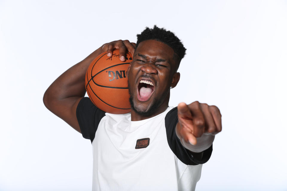 Deandre Ayton displays his planned response to anyone who rags him about securing the bag by signing with Puma. (Getty)