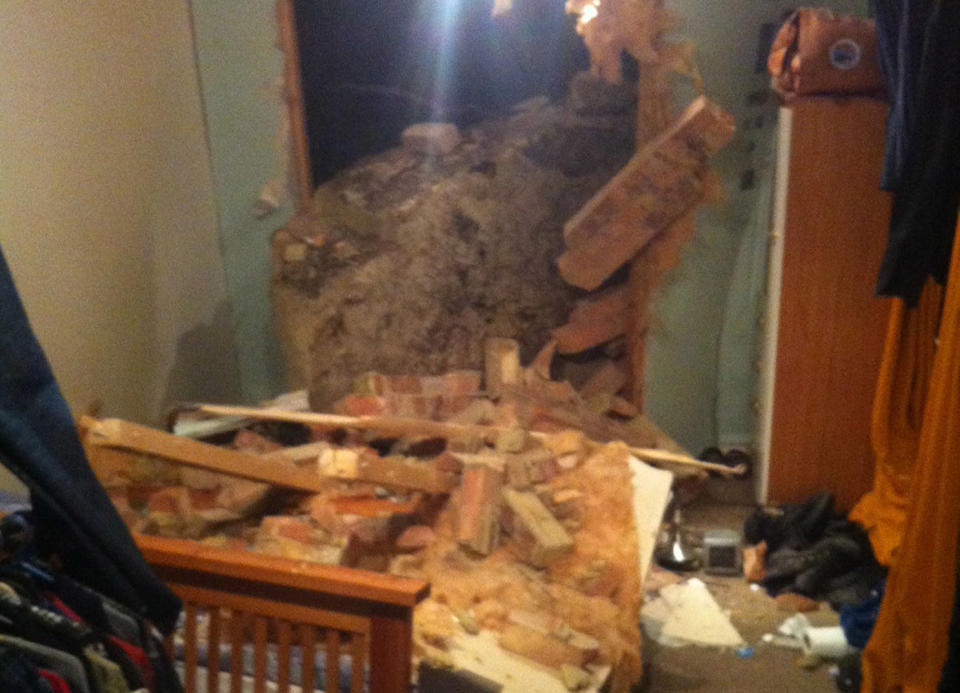 <em>The giant boulder fell and smashed through the wall of a man’s bedroom (Picture: PA/East Sussex Fire & Rescue Service)</em>