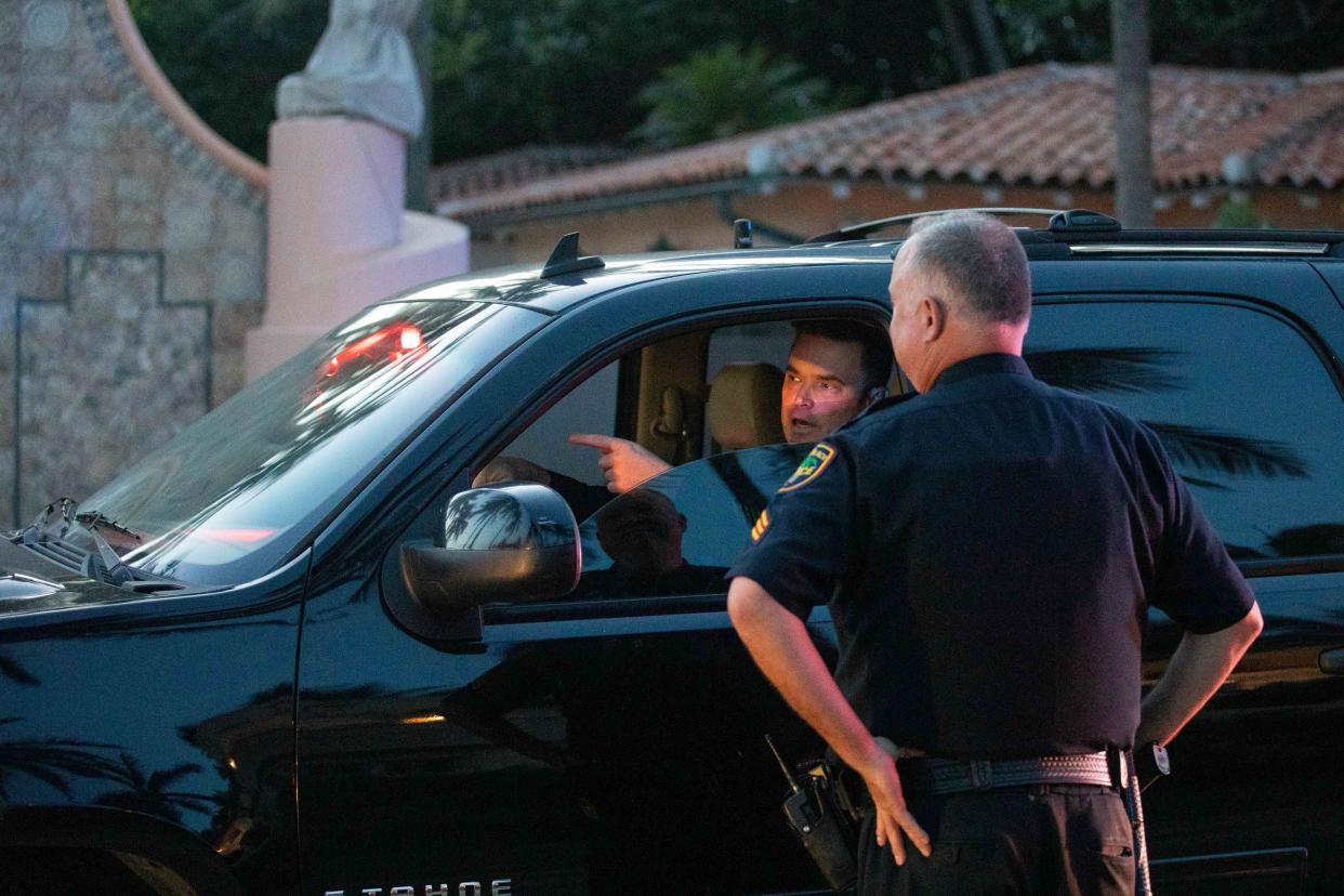 Palm Beach Police officers speak near Mar-A-Lago in Palm Beach, Fla., on Monday, August 8, 2022. 