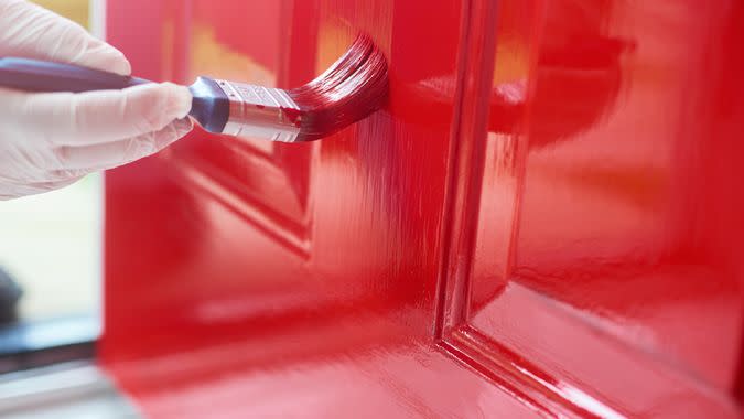 Homeowner gives his front door a new bold lick of paint.