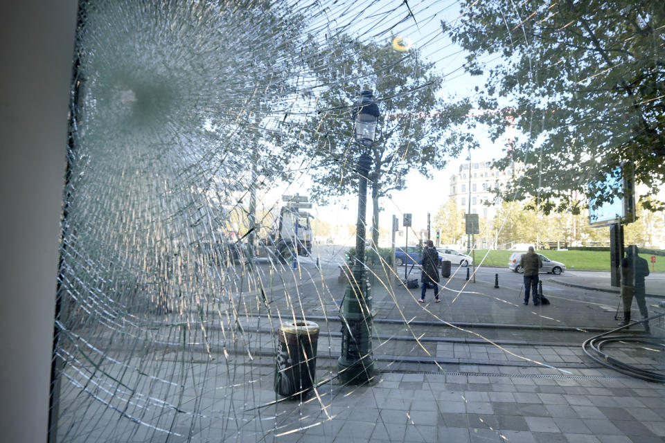A bullet hole is seen on the inside an office building in Brussels, Tuesday, Oct. 17, 2023, close to where two Swedish soccer fans were shot by a suspected Tunisian extremist on Monday night. Police in Belgium have shot dead a suspected Tunisian extremist accused of killing two Swedish soccer fans in a brazen attack on a Brussels street before disappearing into the night on Monday. (AP Photo/Martin Meissner)
