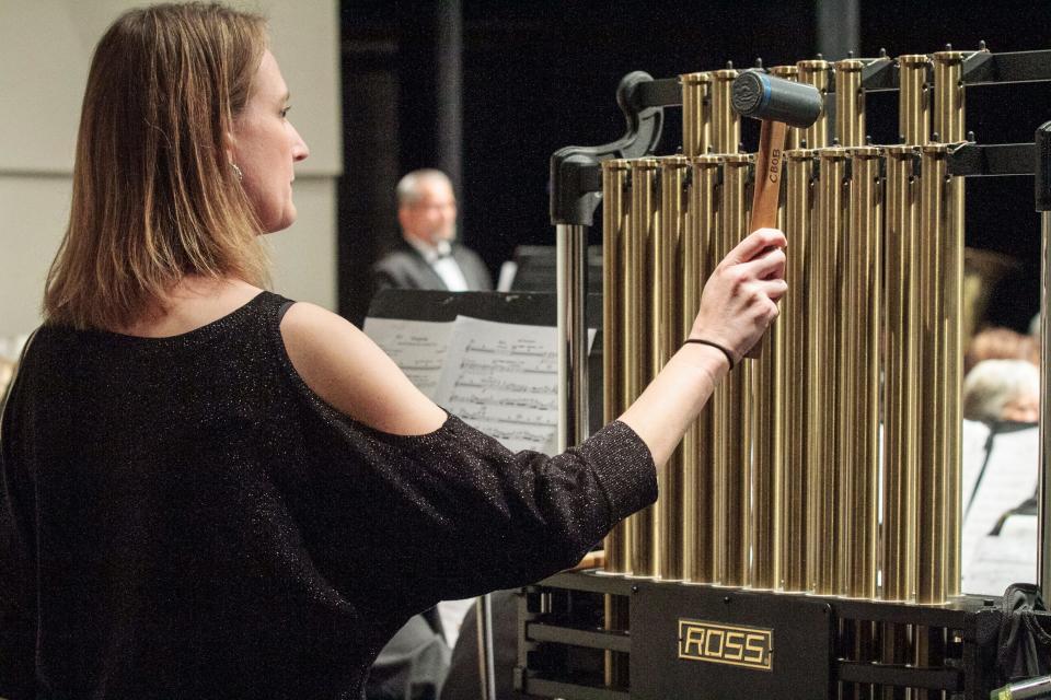 Evie Tompkins strikes the chimes for the Community Band of Brevard’s holiday concert Dec. 4.