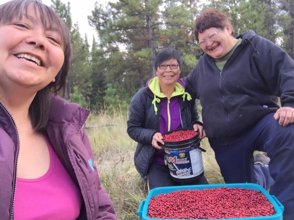 From left, Diane Baxter, Charlotte Kay and Sheila Vittrekwa with their cranberry haul in Whitehorse in 2016.