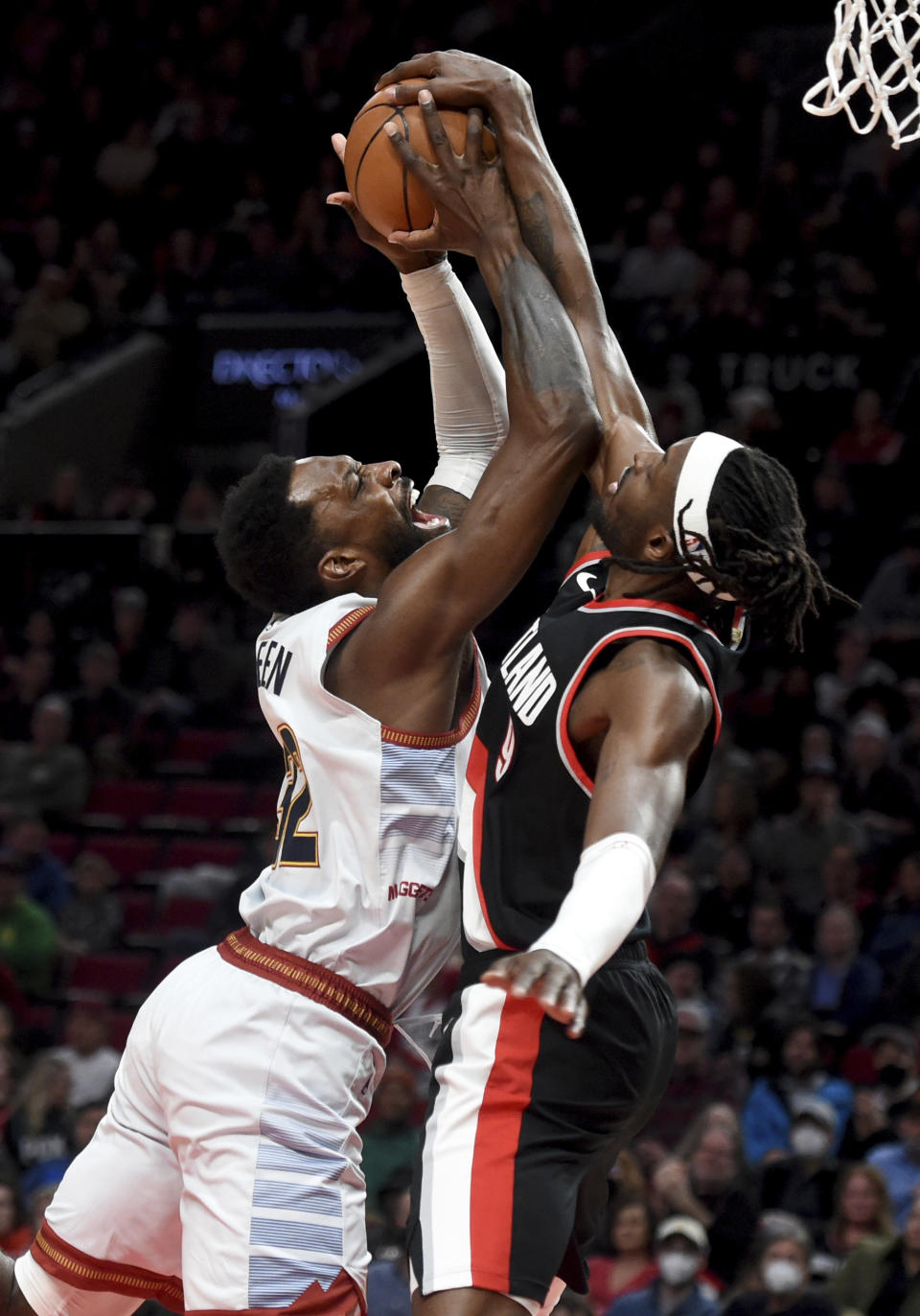 Portland Trail Blazers forward Jerami Grant, right, is called for a foul as he blocks the shot of Denver Nuggets forward Jeff Green during the first half of an NBA basketball game in Portland, Ore., Thursday, Dec. 8, 2022. (AP Photo/Steve Dykes)