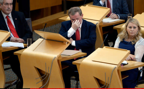 Scottish Labour interim leader Alex Rowley (C) and front bench colleagues Iain Gray (L) and Pauline McNeill (R) during First Minister's Questions in the Scottish Parliament - Credit: Corbis News