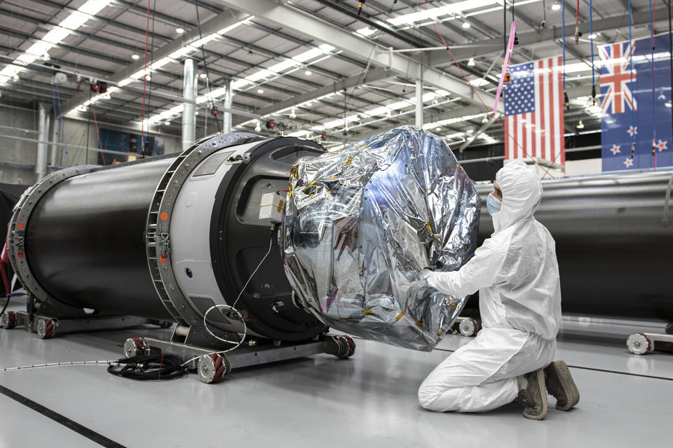 In this photo released by Rocket Lab, a technician works on a component of Rocket Lab's Electron rocket ahead of the launch on the Mahia peninsula in New Zealand on March 10, 2022. NASA plans to send up a satellite to track a new orbit around the moon which it hopes to use in the coming years to once again land astronauts on the lunar surface. (Rocket Lab via AP)