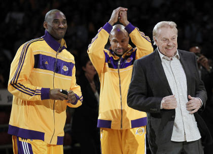 Lakers owner Jerry Buss dishes out the championship jewelry to Kobe Bryant and Derek Fisher in 2010. (AP) 