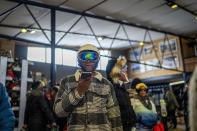 A visitor to the Afriski ski resort waits in line to pay for the ski lift fee, near Butha-Buthe, Lesotho, Saturday July 30, 2022. While millions across Europe sweat through a summer of record-breaking heat, Afriski in the Maluti Mountains is Africa's only operating ski resort south of the equator. It draws people from neighboring South Africa and further afield by offering a unique experience to go skiing in southern Africa. (AP Photo/Jerome Delay)