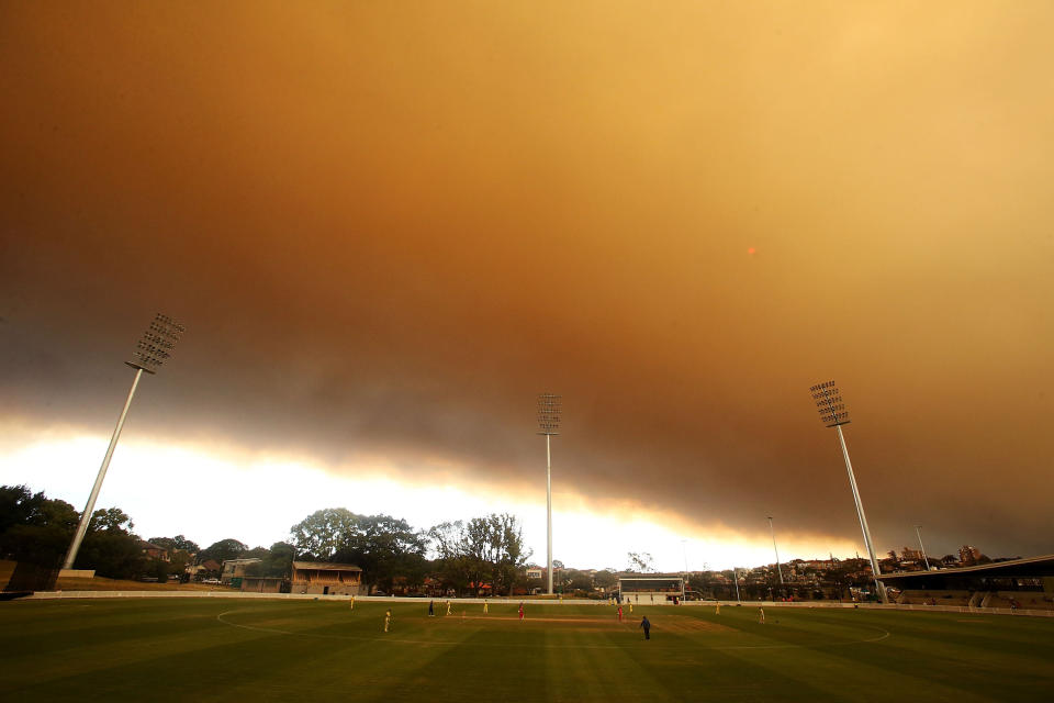 A general view of play as the skyline is shrouded in smoke during the Ryobi Cup match between the South Australian Redbacks and the Western Australia Warriors at Drummoyne Oval on October 17, 2013 in Sydney, Australia.  (Photo by Mark Metcalfe/Getty Images)