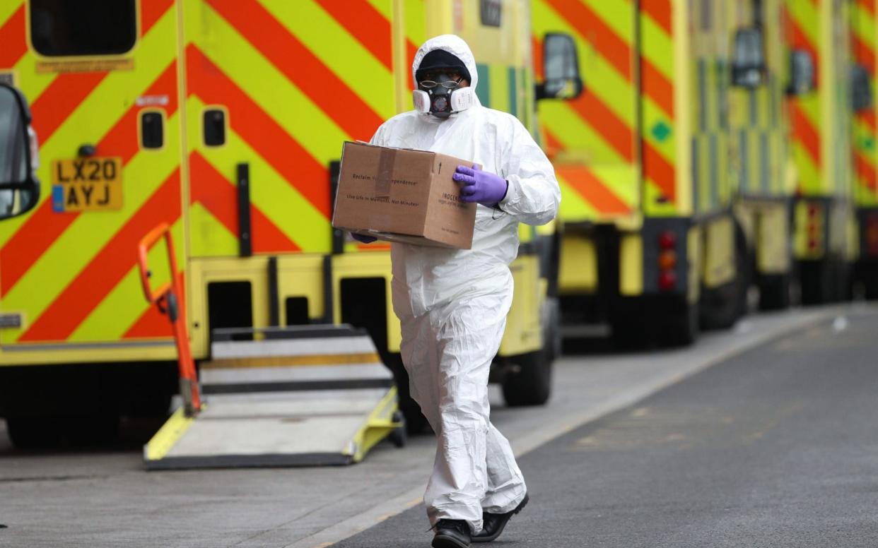 A man wearing PPE makes a delivery to the Royal London Hospital during England's third national lockdown to curb the spread of coronavirus -  Yui Mok / PA