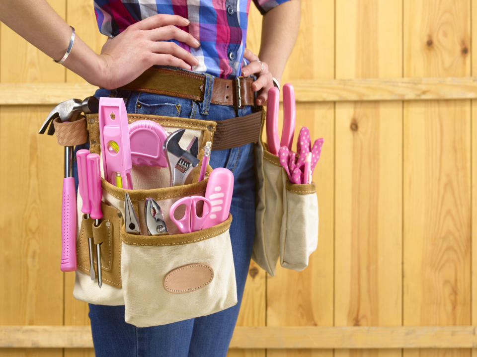 A tool belt with pink tools around a person's waist