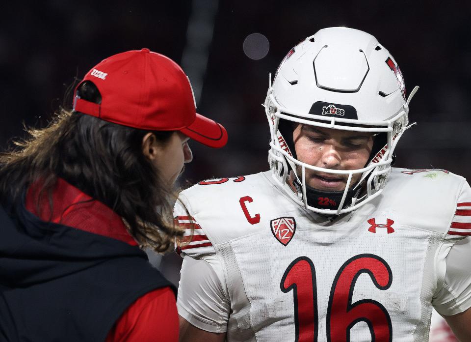 Utah Utes quarterback Cam Rising speaks to Bryson Barnes after Barnes threw an interception on Oct. 21, 2023.