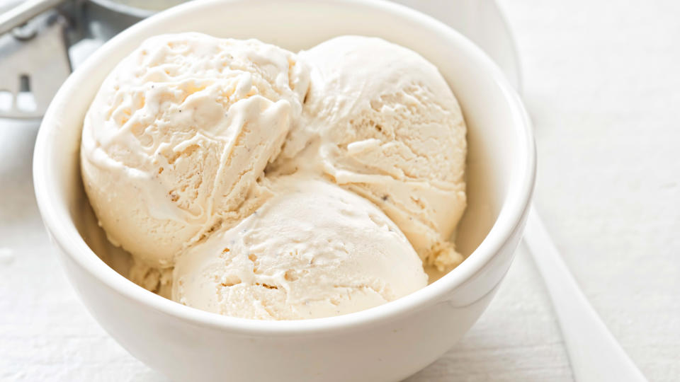 Vanilla ice cream scoops in white bowl