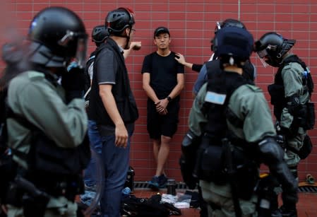 An anti-government protester is detained during a march in Tuen Mun, Hong Kong