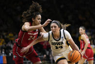 Iowa forward McKenna Warnock (14) drives to the basket past Georgia forward Brittney Smith (24) in the second half of a second-round college basketball game in the NCAA Tournament, Sunday, March 19, 2023, in Iowa City, Iowa. (AP Photo/Charlie Neibergall)