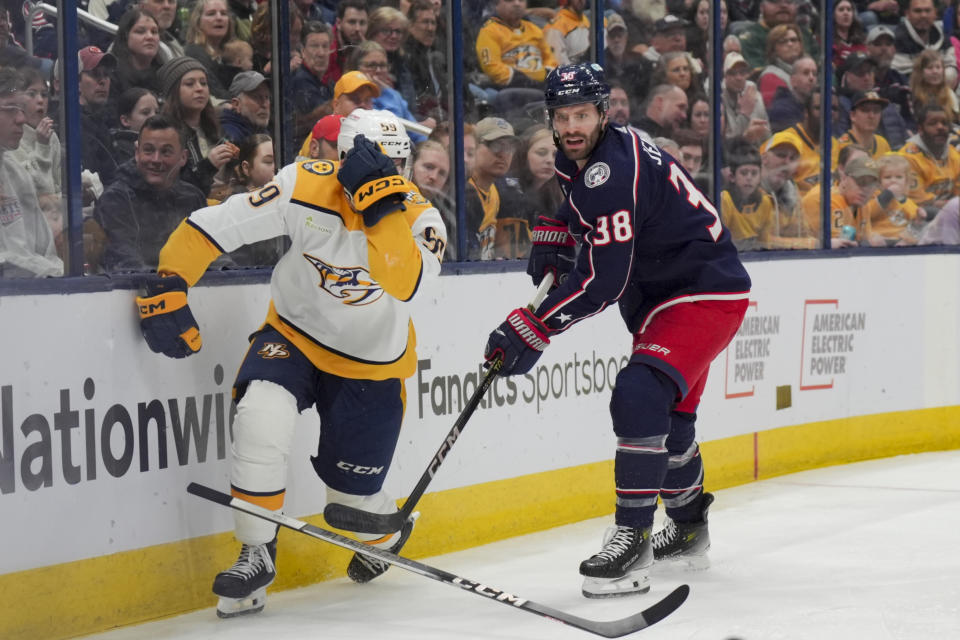 Nashville Predators' Roman Josi, left, reacts after drawing a penalty against Columbus Blue Jackets' Boone Jenner, right, during the second period of an NHL hockey game, Saturday, March 9, 2024, in Columbus, Ohio. (AP Photo/Aaron Doster)