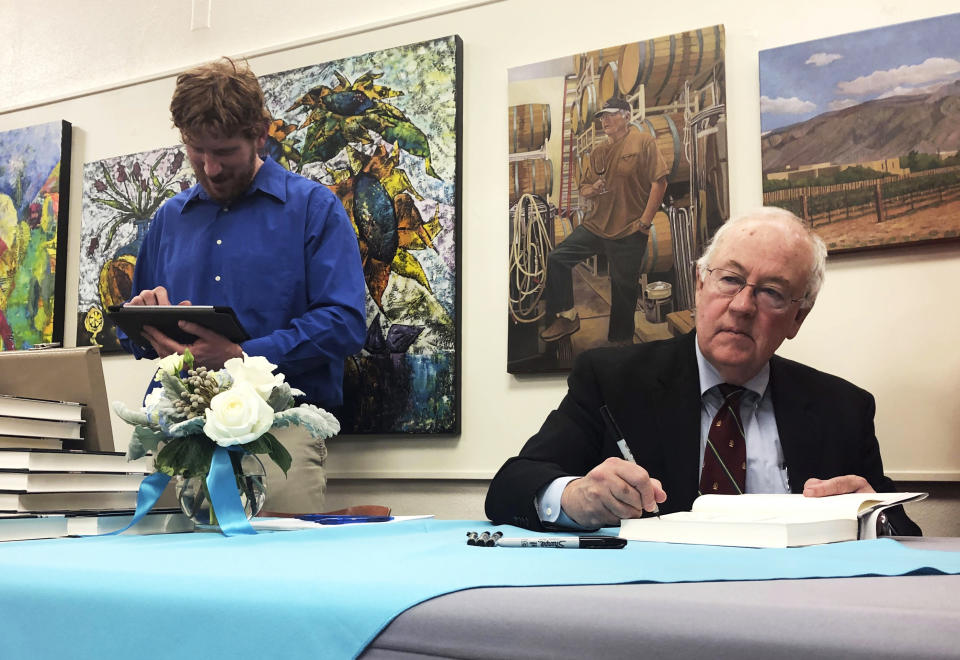 Former independent counsel Kenneth Starr signs a copy of his recent book "Contempt: A Memoir of the Clinton Investigation" at the University of New Mexico School of Law in Albuquerque, N.M., Wednesday, Jan. 23, 2019. Starr, who investigated President Bill Clinton, says he wants the public to trust the checks and balances in the system established to hold presidents accountable. (AP Photo/Mary Hudetz).
