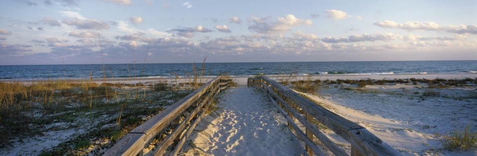 sandy walkway leading to a beach