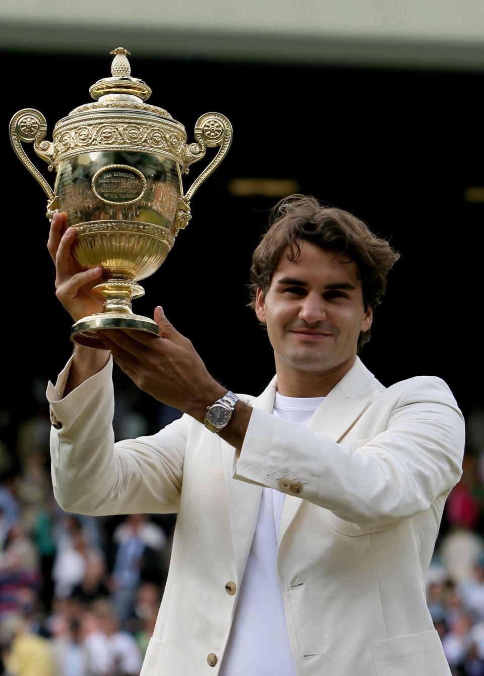 <p>Roger Federer of Switzerland holds aloft the trophy after winning the Men’s final against Rafael Nadal on July 9, 2006 in London, England. </p>