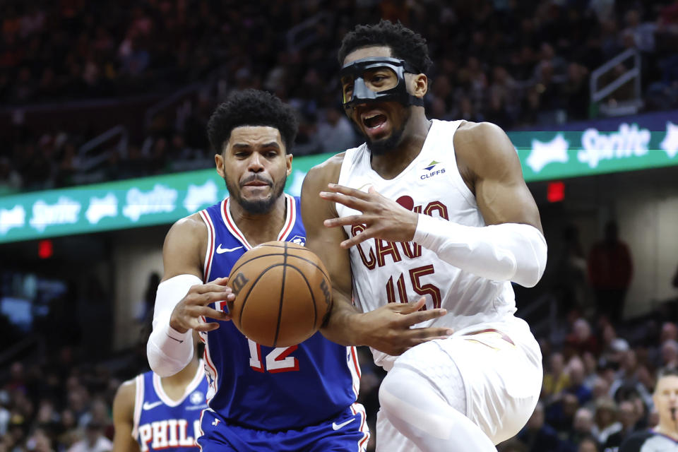 Philadelphia 76ers forward Tobias Harris (12) steals the ball from Cleveland Cavaliers guard Donovan Mitchell (45) during the second half of an NBA basketball game Friday, March 29, 2024, in Cleveland. (AP Photo/Ron Schwane)