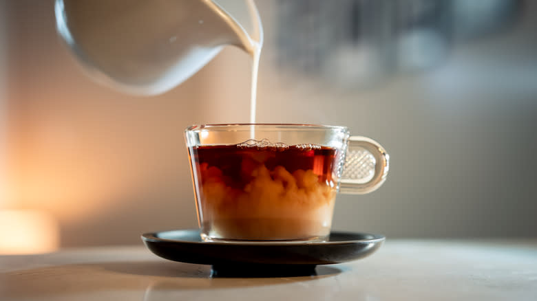 Pouring milk in tea