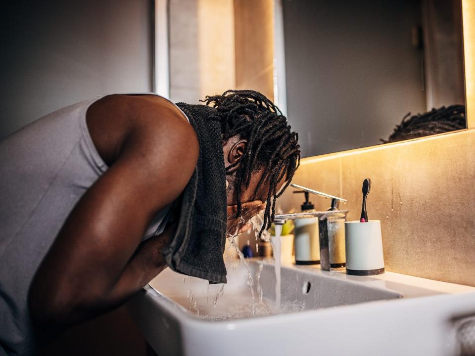A man washing his face with cleanser