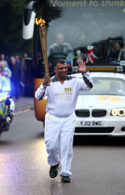 Queens Park Rangers Chairman, Tony Fernandes carries the Olympic Flame on the Torch Relay leg between St Ives and Huntingdon.