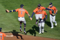 Houston Astros' Carlos Correa, left, and Houston Astros' George Springer, leap in celebration after they defeated the Minnesota Twins 3-1 in Game 2 to clinch the American League wild-card baseball series, Wednesday, Sept. 30, 2020, in Minneapolis. (AP Photo/Jim Mone)