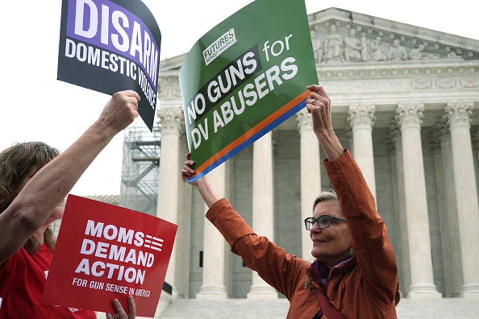 Activists hold up signs outside US Supreme Court during a gun-control rally on 7 November 2023 in Washington, DC. (Getty Images)