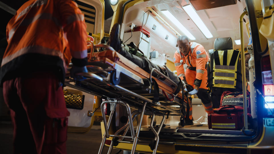 person in a stretcher being put inside the emt truck