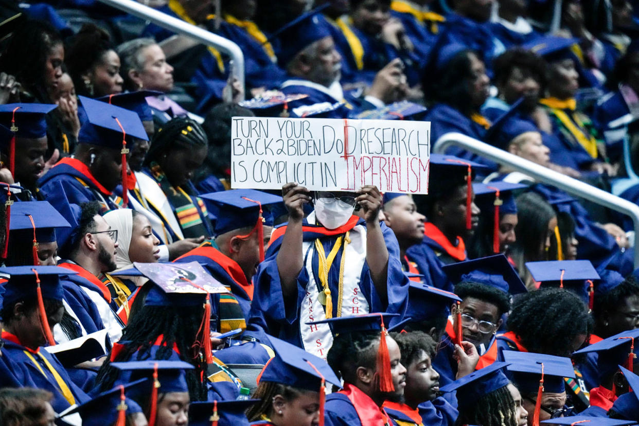 A graduate holds a sign (Alex Brandon / AP file)