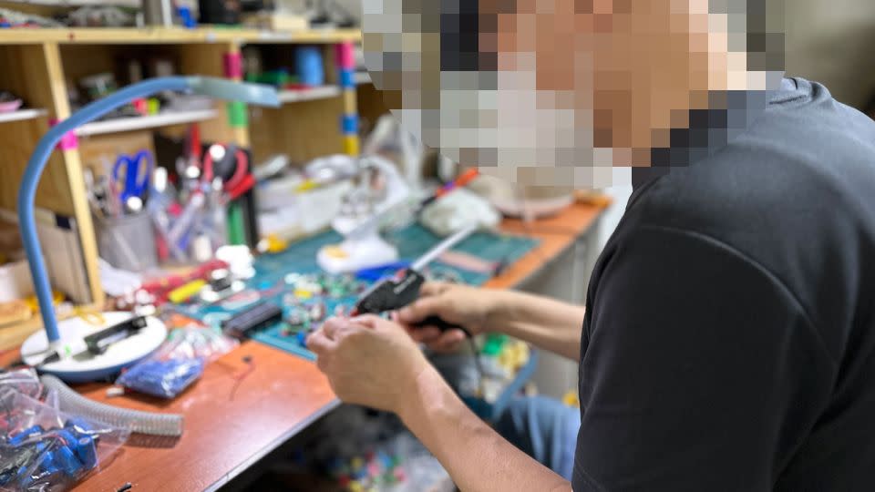 Choi pictured in the apartment rented by his activist group as a base of operations. A portion of this image has been obscured to protect the subject's identity. - Yoonjung Seo/CNN