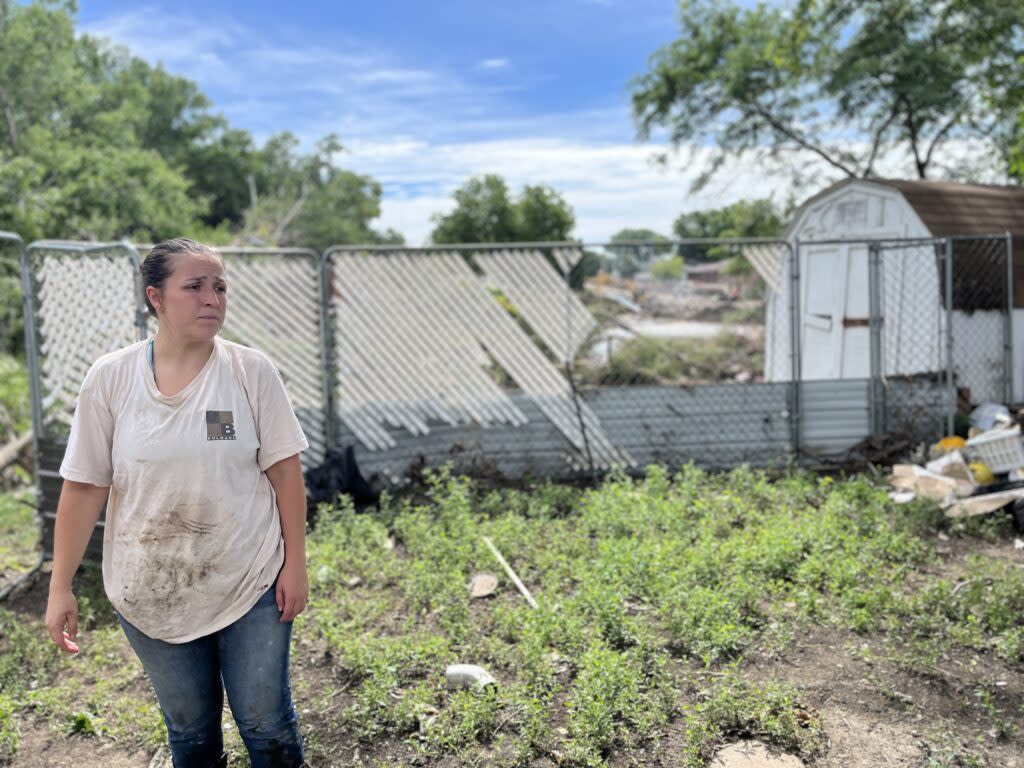 Morgan Speichinger works to clean up her home near McCook Lake on July 3, 2024, after a June 23 flood. (Joshua Haiar/South Dakota Searchlight)