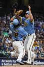 Milwaukee Brewers' Aaron Ashby colides with Keston Hiura as he catches a ball hit by Cincinnati Reds' Kyle Farmer during the fifth inning of a baseball game Saturday, Aug. 6, 2022, in Milwaukee. (AP Photo/Morry Gash)