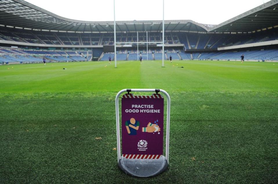 Edinburgh players train with a health warning sign at Murrayfield.