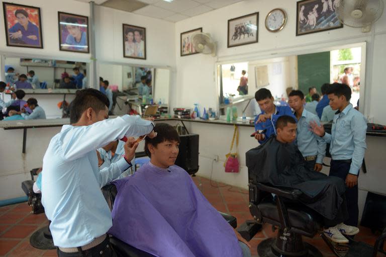 Deaf Cambodian students train at a hairdresser's shop in Phnom Penh, on October 15, 2014