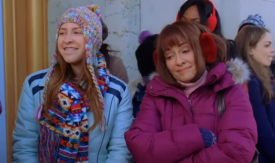  Eden Sher as Sue and Patricia Heaton as Frankie standing and smiling in The Middle. 