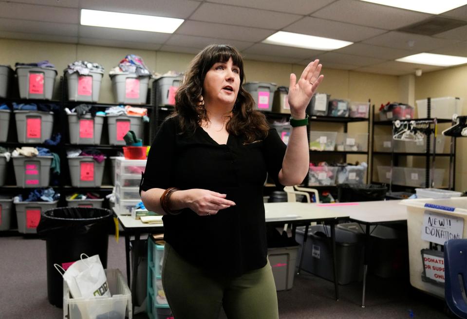 Beth Strano, asylum seekers and families engagement manager, shows the clothing storage room at the Welcome Center in Phoenix on July 12, 2023. The Welcome Center marks four years of providing shelter, food and other humanitarian assistance to asylum seekers released by federal immigration authorities. Some credit the center for eliminating the street releases of asylum seekers in the past and alleviating the strain placed on local churches that had stepped in to accommodate them.