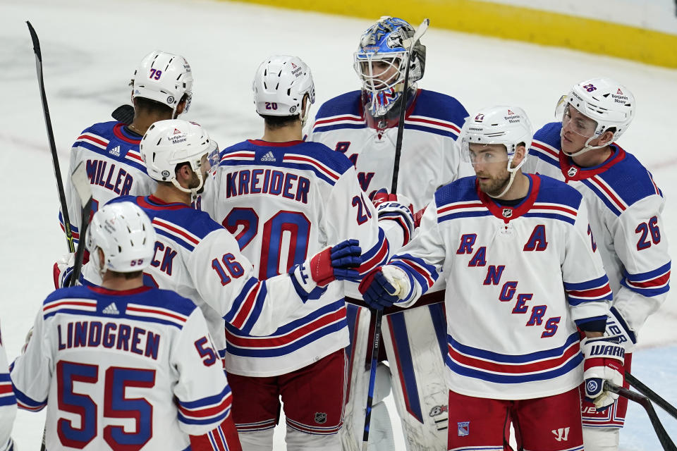 New York Rangers goaltender Igor Shesterkin, top, celebrates with teammates after their 7-3 win against the Minnesota Wild in an NHL hockey game Thursday, Oct. 13, 2022, in St. Paul, Minn. (AP Photo/Abbie Parr)